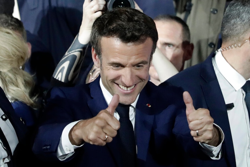 Emmanuel Macron gives a double thumbs up.