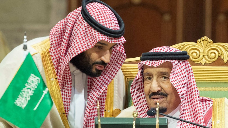 Saudi Crown Prince Mohammed bin Salman leans in to hear King Salman bin Abdulaziz Al Saud