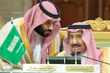 Saudi Crown Prince Mohammed bin Salman leans in to hear King Salman bin Abdulaziz Al Saud