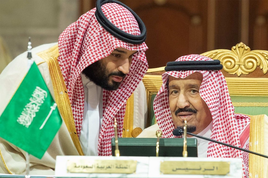 Saudi Crown Prince Mohammed bin Salman leans in to hear King Salman bin Abdulaziz Al Saud