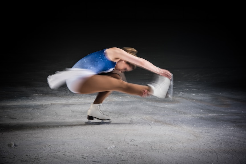 Figure skater stretching arms and legs out