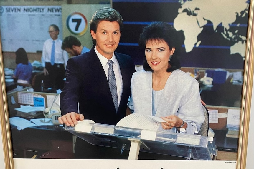 A man and woman at a desk in the 1980s.