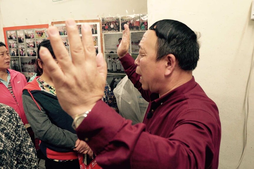 Pastor Wang Zeqing leads his congregation