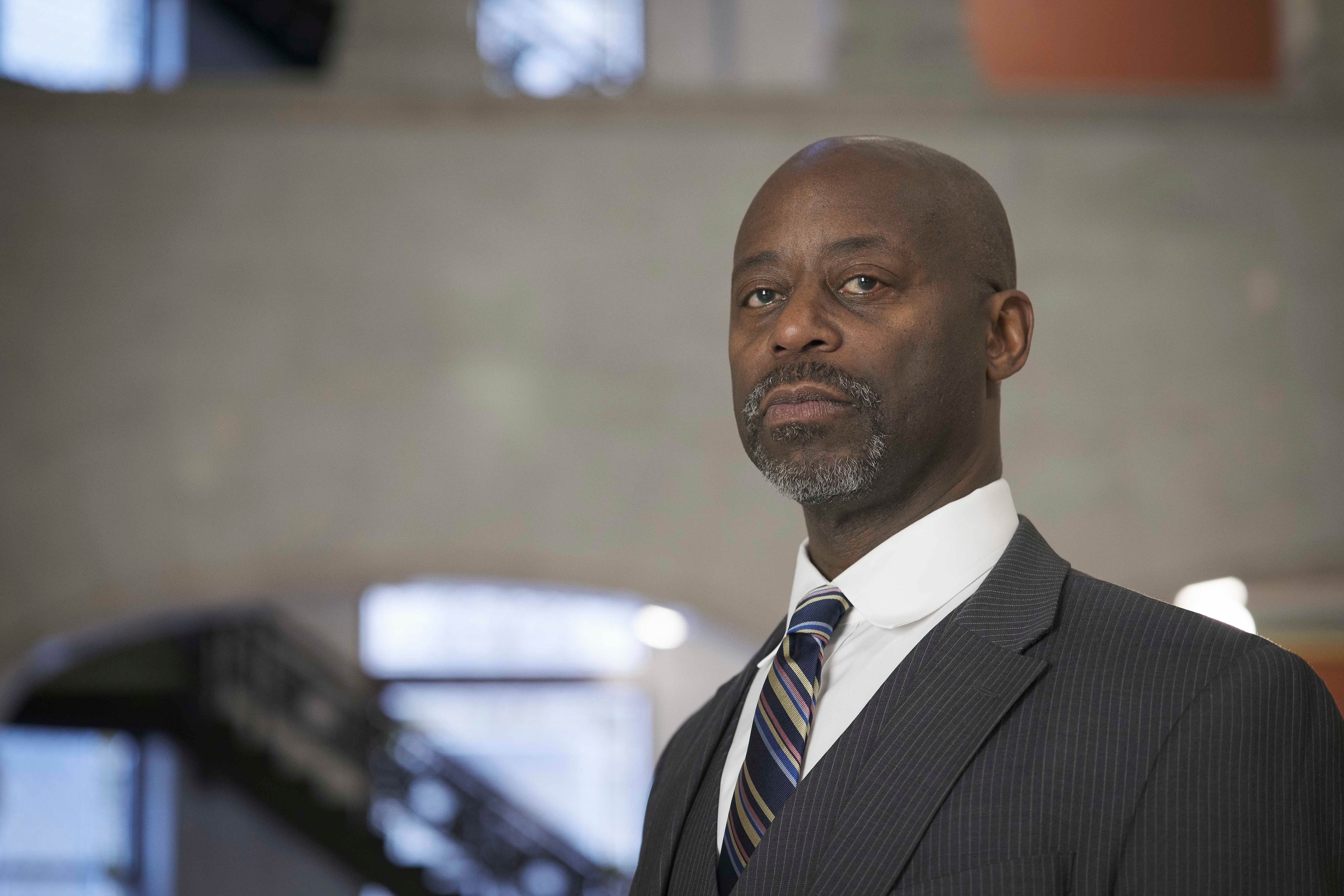 An African American man in a dark grey suit.