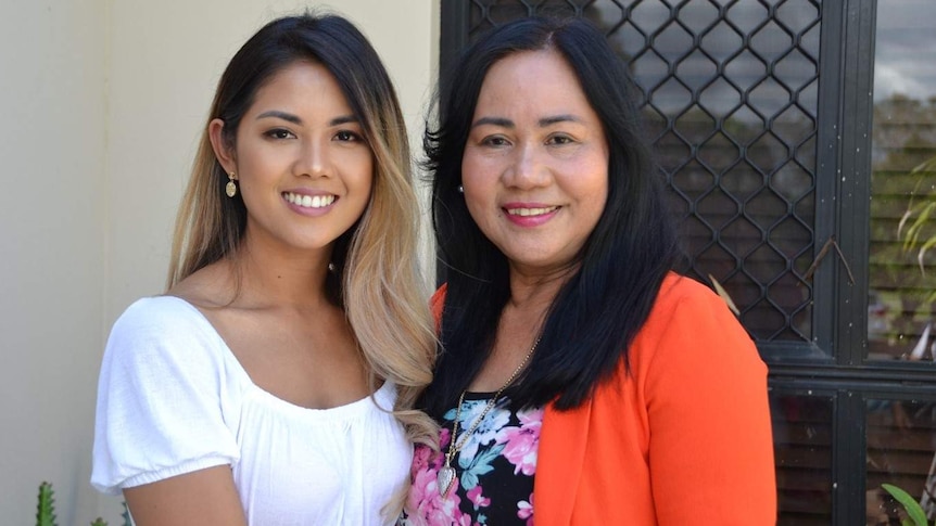 Two women stand side by side