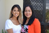 Two women stand side by side