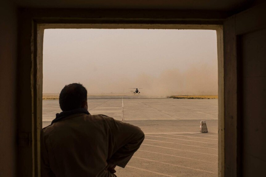 Silhouette of a man looking at a helicopter in Kunduz, Afghanistan.