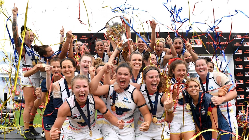 Adelaide Crows celebrate with the inaugural AFLW trophy