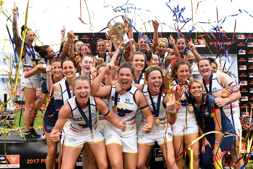 Adelaide Crows celebrate with the inaugural AFLW trophy