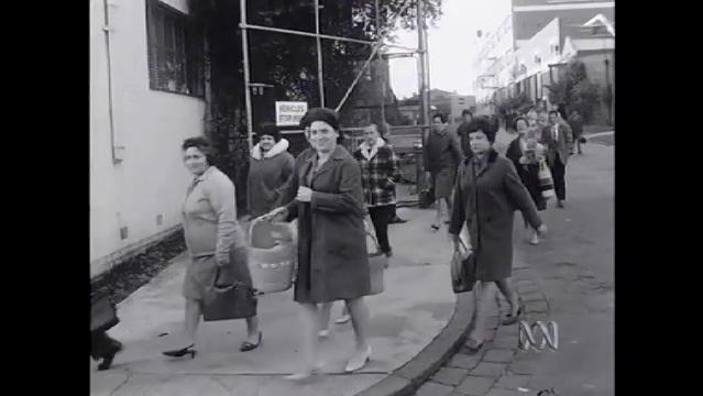 Old photo of women walk to work along street