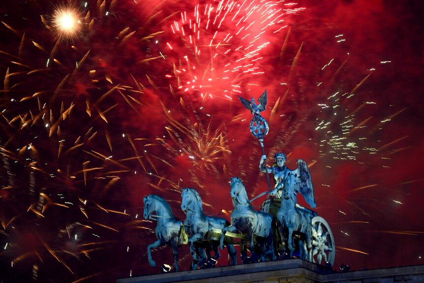 Fireworks explode over the Brandenburg Gate in Berlin, Germany, during New Year's Eve celebrations.