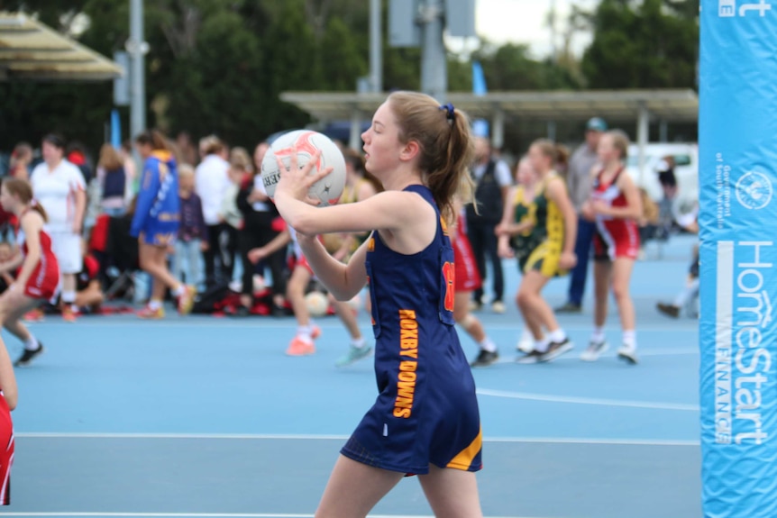 Olivia makes a pass forward with the netball.