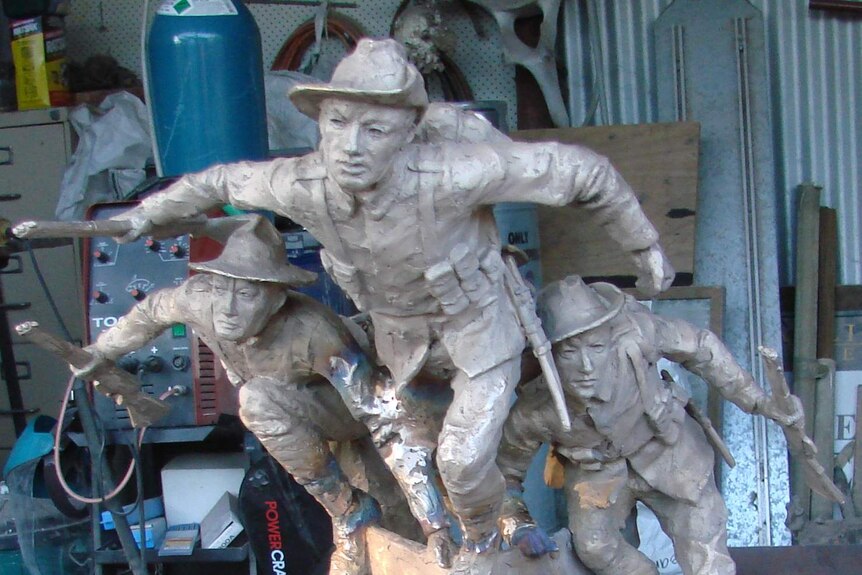 A statue of two Australian diggers and one New Zealander jumping from the bow of a boat at Gallipoli.