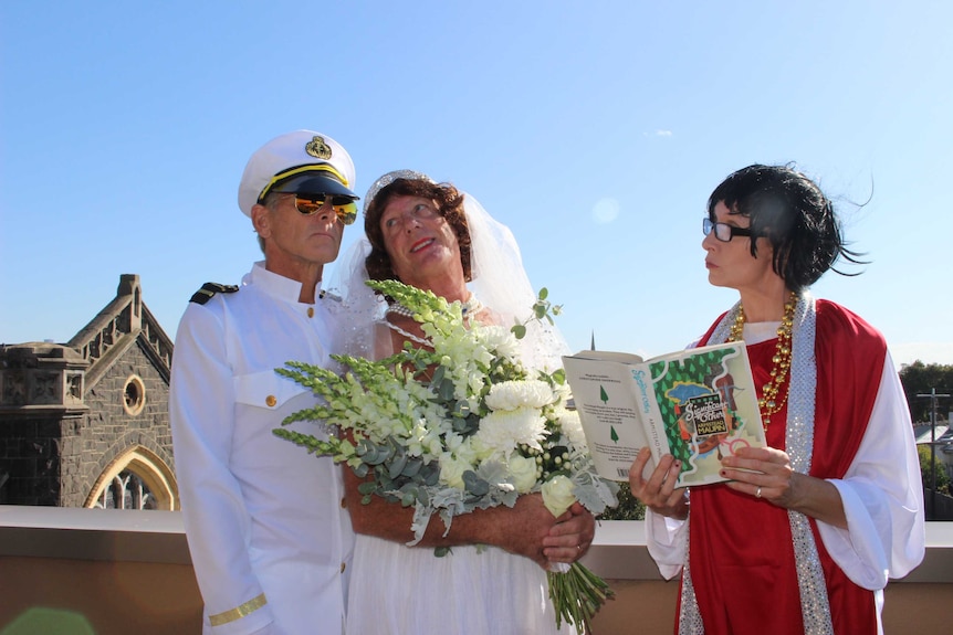 Carl dressed in a sailor outfit, Andrew dressed as a bride and Lisa dressed as a priest