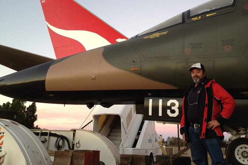 Defence spokesman Peter Cavanagh with retired F-111 jet at Longreach