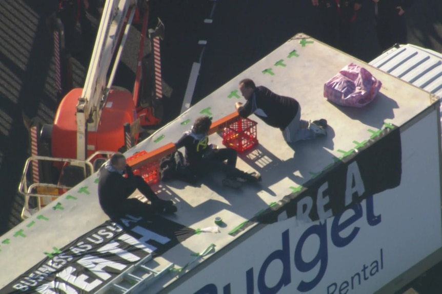 Protesters on top of a truck
