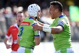 Jarrod Croker is congratulated by Josh Papalii after his try for Canberra against Wests Tigers