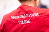 A red shirt with 'vaccination team' written on the back.