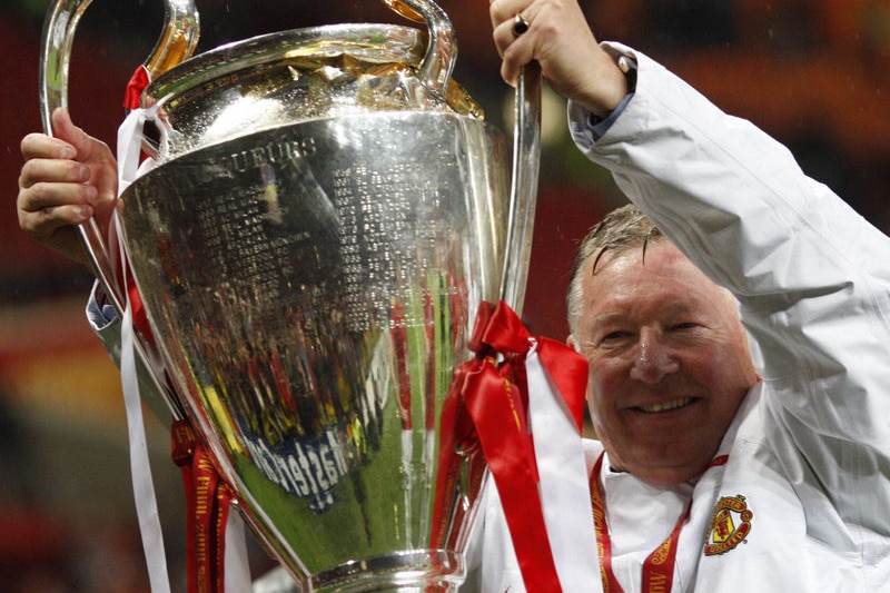 Alex Ferguson holds up the trophy