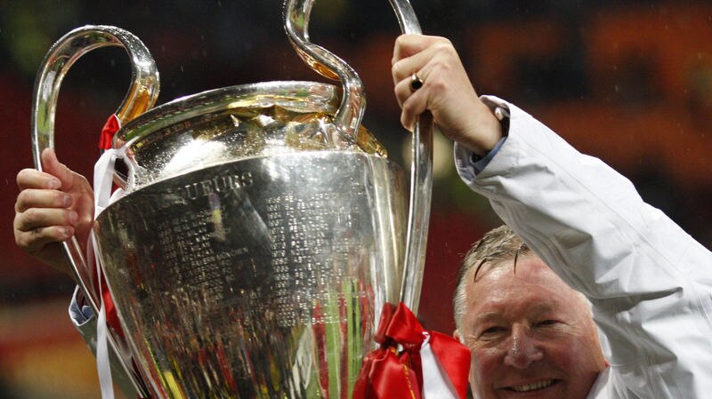 Alex Ferguson holds up the trophy