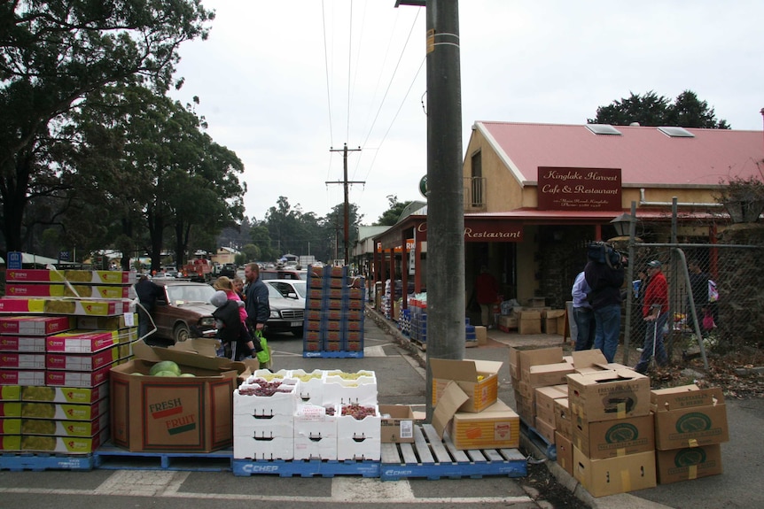 Kinglake main street with piles of food and boxes outside shops.