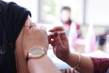 Nurse injects vaccine into arm
