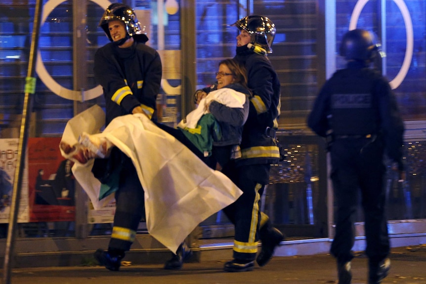 Fire brigade members carry an injured individual