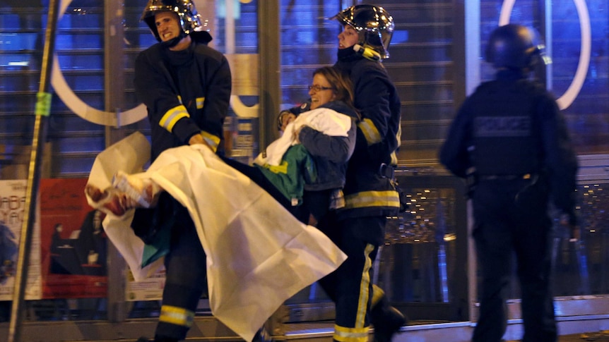 Fire brigade members carry an injured individual