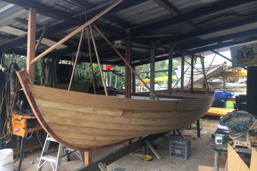 A rowboat in the process of being built. It is yet to be painted.