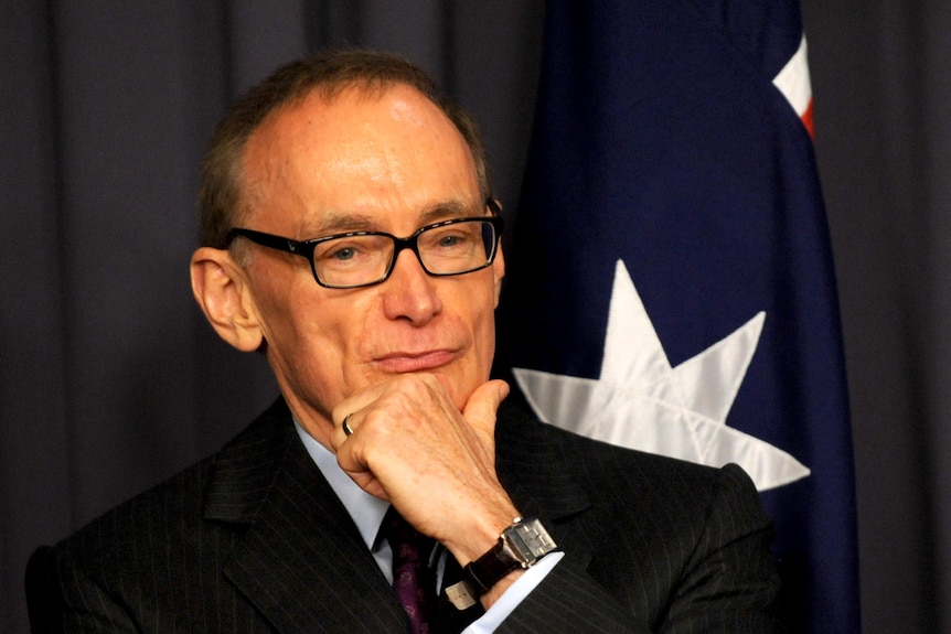 Former NSW premier Bob Carr listens to Prime Minister Julia Gillard speak.