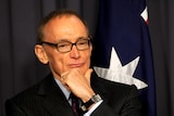 Bob Carr listens to Julia Gillard