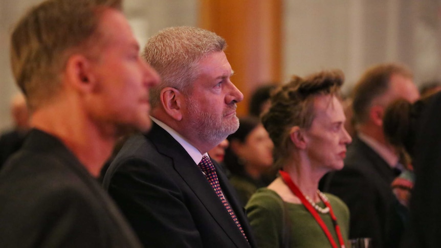 Australian actors Richard Roxburgh (left) and Judy Davis (right) with Arts Minister Mitch Fifield (centre) watch the speakers