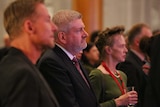 Australian actors Richard Roxburgh (left) and Judy Davis (right) with Arts Minister Mitch Fifield (centre) watch the speakers