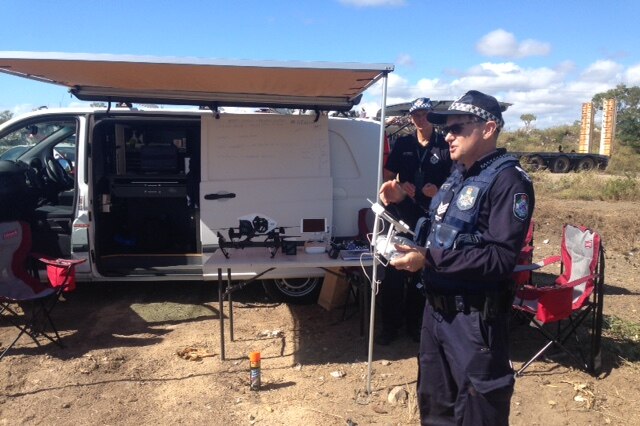 Police officer with drone being used to map dump site.