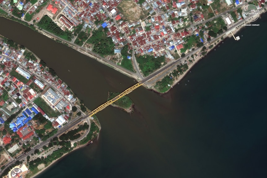 This August 17, 2018, satellite photo provided by DigitalGlobe shows a view of the Jembalanbridge in Palu, Indonesia.
