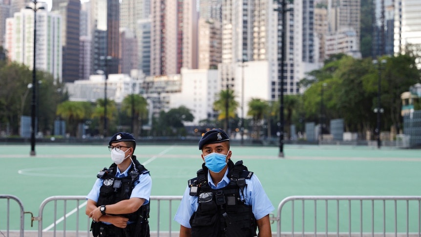 .Police officers stand guard at Victoria Park, where the candlelight vigil used to be held,