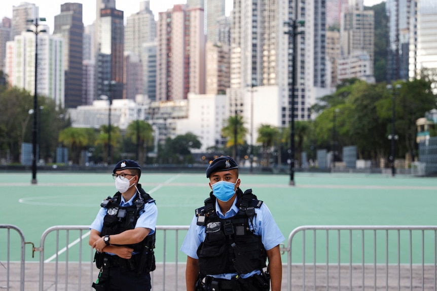 .Police officers stand guard at Victoria Park, where the candlelight vigil used to be held,