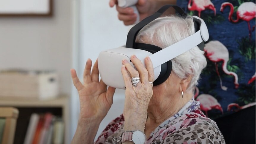 An older woman wearing a virtual reality headset.