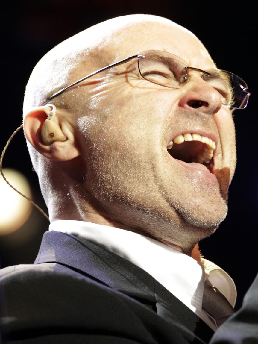 Close up of a suited man singing.