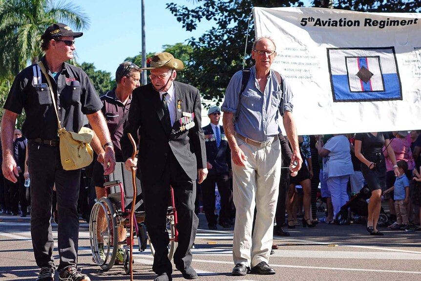 Kokoda Track veteran Arnold Forrester (centre) marching in Townsville