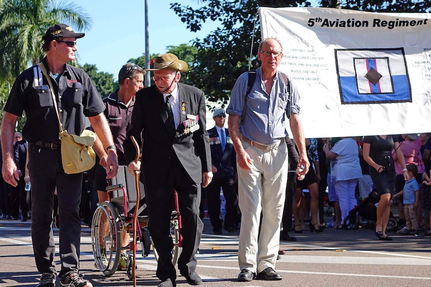 Kokoda Track veteran Arnold Forrester (centre) marching in Townsville