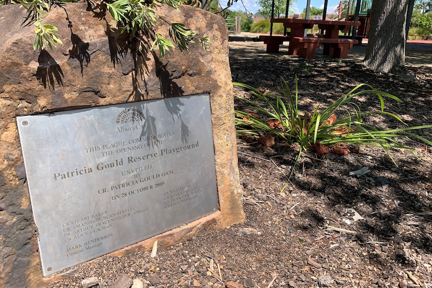 Patrica Gould playground plaque in stone at the front of a picnic area 