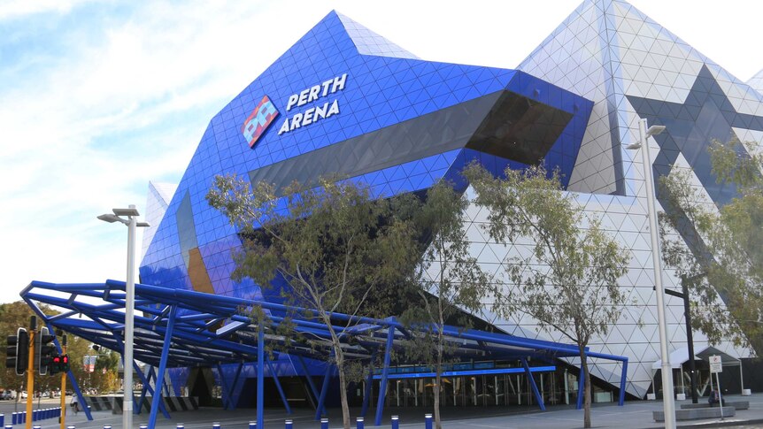 Exterior of building with blue roof with trees out of the front.  Perth Arena sign on top.