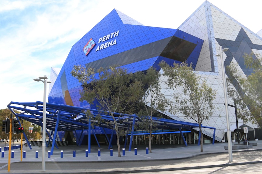 Exterior of building with blue roof with trees out of the front.  Perth Arena sign on top.