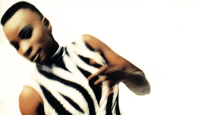 Blurry photo of Angélique Kidjo dancing, from the cover of her album Logozo