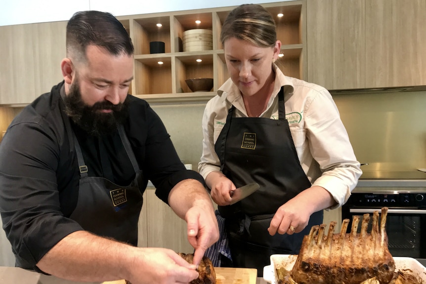 Zeb Gilbert and Melinda Murnane putting the finishing touches to a roast pork dish.