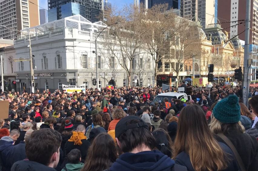 Hundreds of people fill steps of Parliament and Spring Street in Melbourne's CBD.