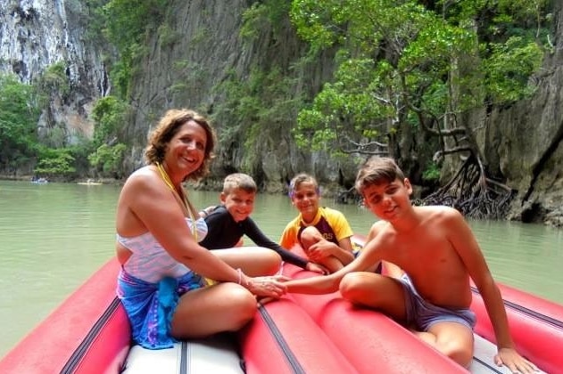Susan Sullivan (left), Tommy Boyd, Jackson Boyd and Daniel Boyd in a boat on the water in Thailand.