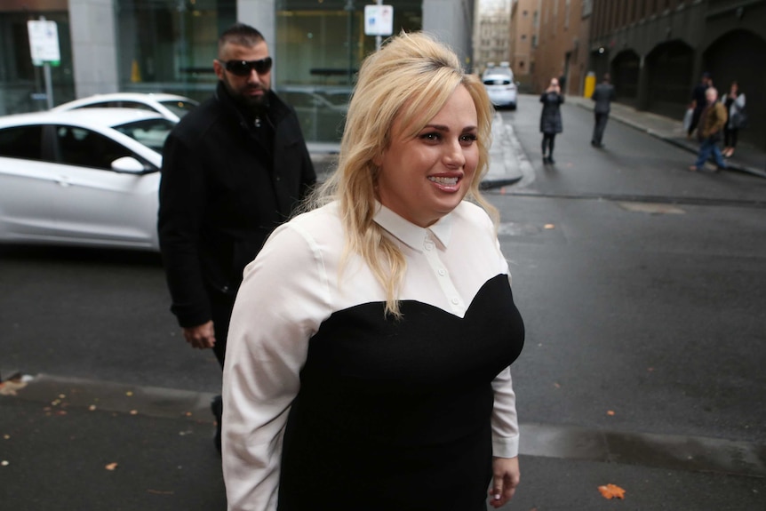 Rebel Wilson smiles as she arrives at the Supreme Court.