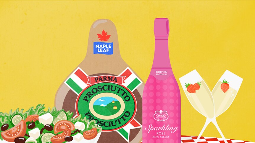 An illustration shows a bowl of salad with feta-like cheese, a leg of Canadian "Prosciutto" and a bottle of "sparkling rose"